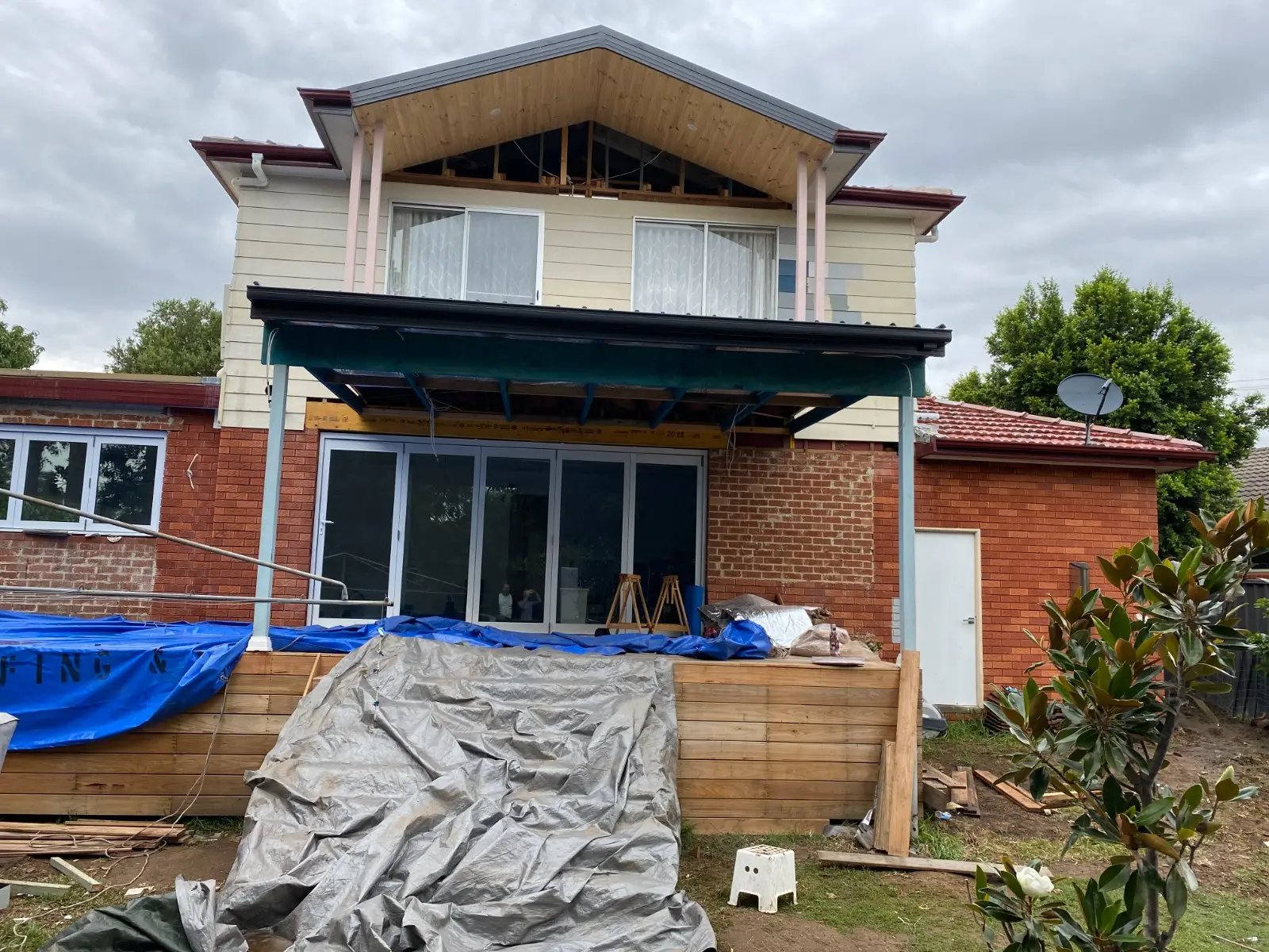 Original kitchen pass-through and balcony framing before transformation